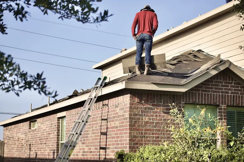 Professional roofer working on a residential roof in North River Shores